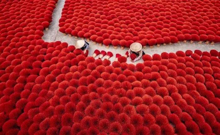Workers Arranging Red Incense Sticks for Drying | Vietnam Photo Tours | workshopsphototours.com