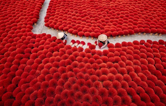 Workers Arranging Red Incense Sticks for Drying | Vietnam Photo Tours | workshopsphototours.com