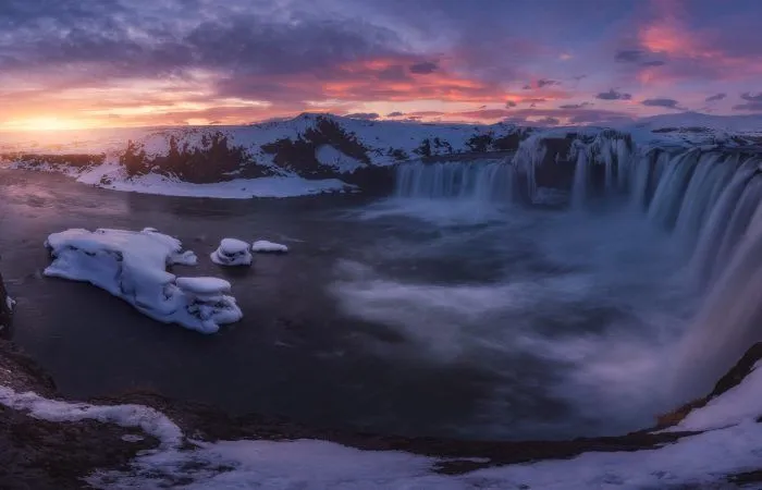 a waterfall in a snowy landscape